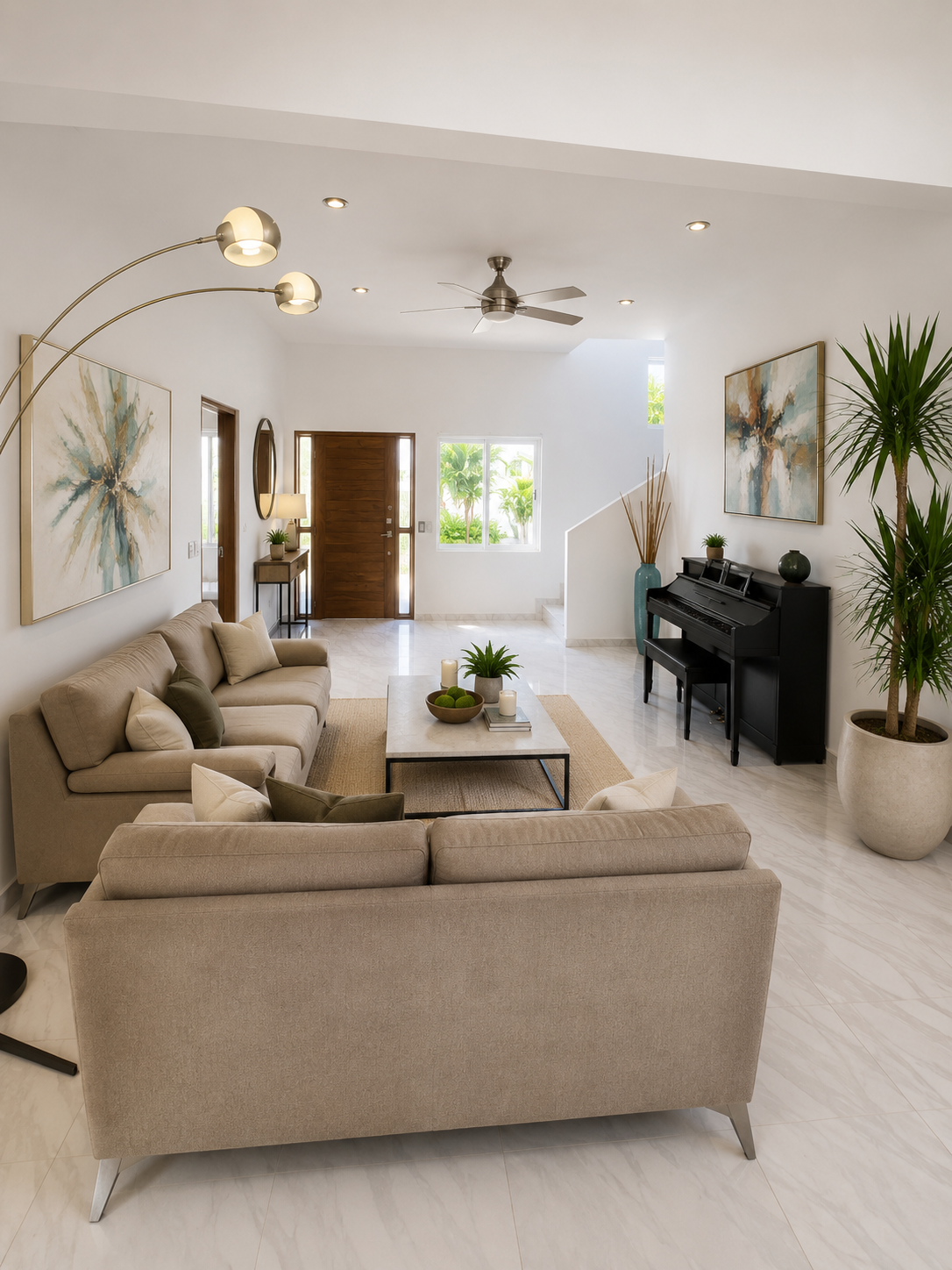 Casa Claudia entry hall with double-height ceiling, piano, and wood front door